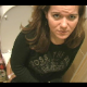 A European woman strains while farting loudly and pooping on a toilet.